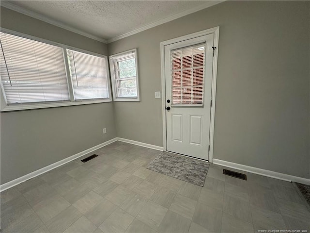 3513 Greenwood Dr, Fayetteville, NC 28311 - entryway featuring a textured ceiling, crown molding, and tile patterned floors