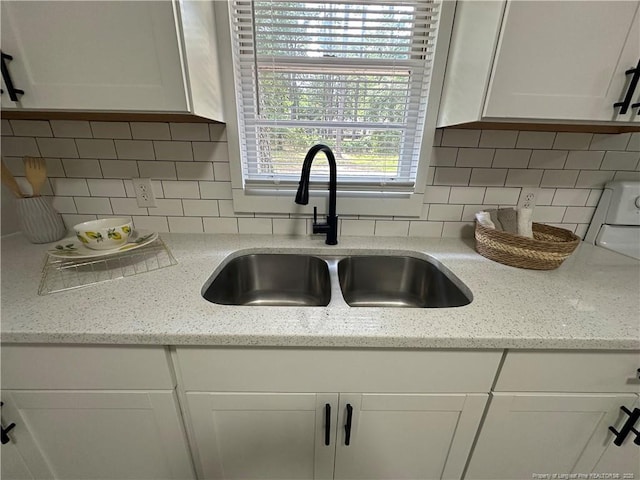 3513 Greenwood Dr, Fayetteville, NC 28311 - kitchen view of white cabinetry, tasteful backsplash, and light stone countertops