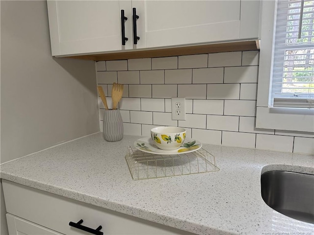 3513 Greenwood Dr, Fayetteville, NC 28311 - kitchen view of backsplash, white cabinets, and light stone countertops