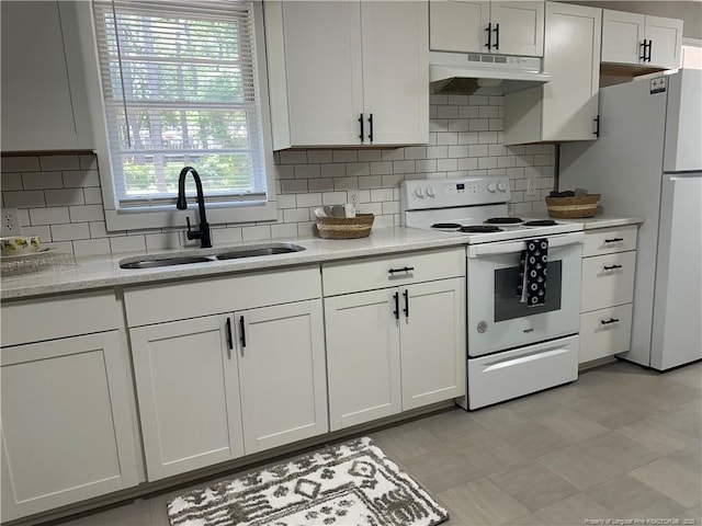 3513 Greenwood Dr, Fayetteville, NC 28311 - kitchen featuring white appliances, under cabinet range hood, white cabinetry, and backsplash