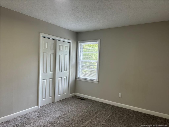 3513 Greenwood Dr, Fayetteville, NC 28311 - unfurnished bedroom with carpet, a textured ceiling, and a closet