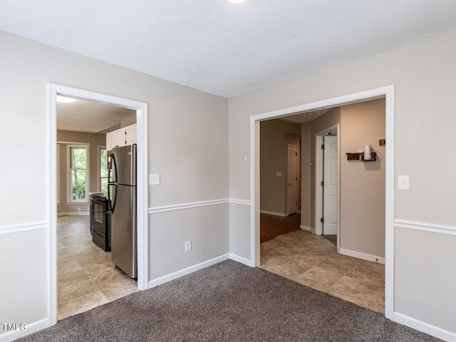 23 Joci Ct, Durham, NC 27704 - spare room featuring light colored carpet, light tile patterned floors, and a textured ceiling