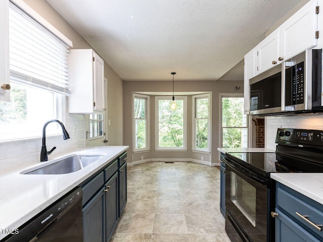 23 Joci Ct, Durham, NC 27704 - kitchen with black appliances, white cabinetry, light countertops, decorative backsplash, and decorative light fixtures
