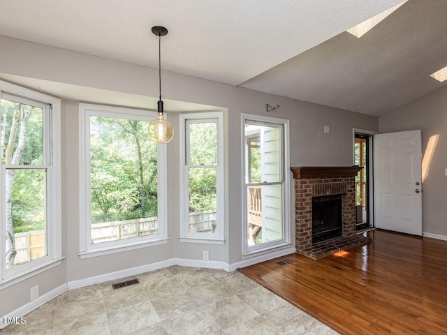 23 Joci Ct, Durham, NC 27704 - unfurnished living room featuring a textured ceiling, a brick fireplace, and vaulted ceiling