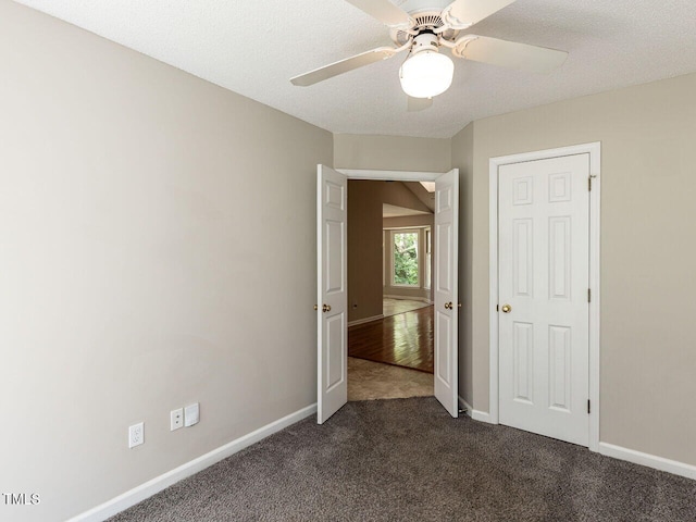23 Joci Ct, Durham, NC 27704 - unfurnished bedroom featuring dark carpet and ceiling fan