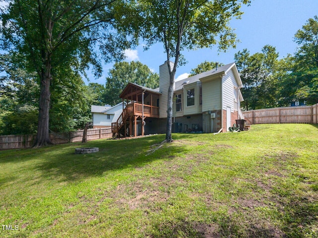23 Joci Ct, Durham, NC 27704 - back of house with stairway, a chimney, a fire pit, a fenced backyard, and a wooden deck