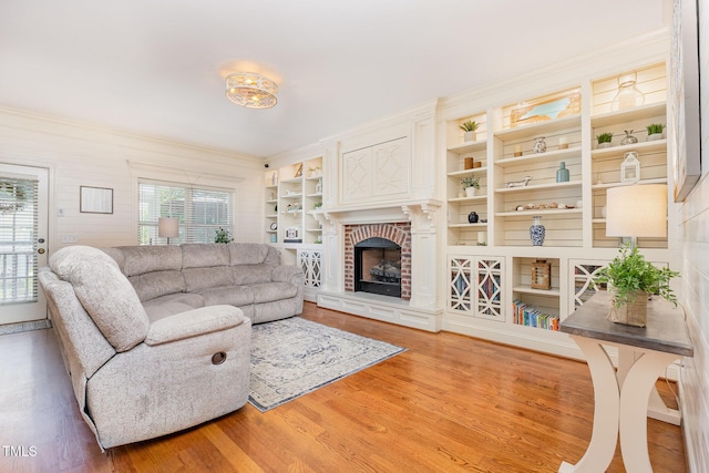 114 Boone Trl, Garner, NC 27529 - living area featuring wood finished floors, healthy amount of natural light, ornamental molding, a fireplace, and built in shelves