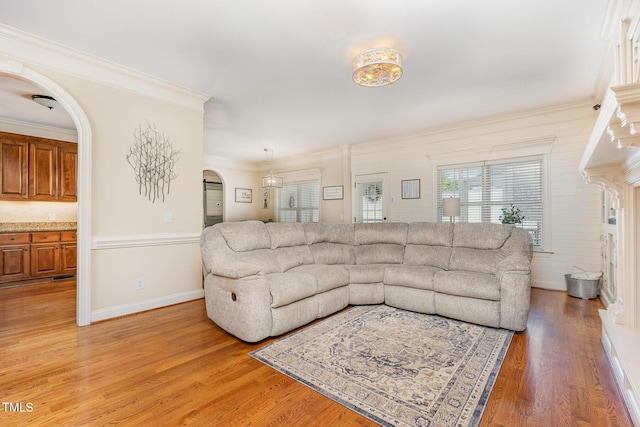 114 Boone Trl, Garner, NC 27529 - living area with ornamental molding, arched walkways, and light wood-style flooring