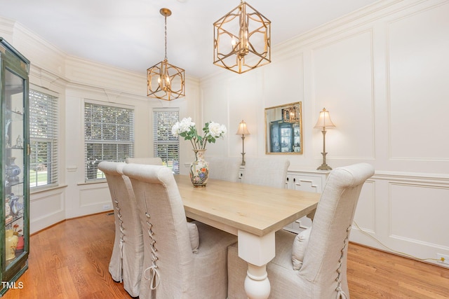 114 Boone Trl, Garner, NC 27529 - dining area with a decorative wall, a chandelier, light wood finished floors, and ornamental molding