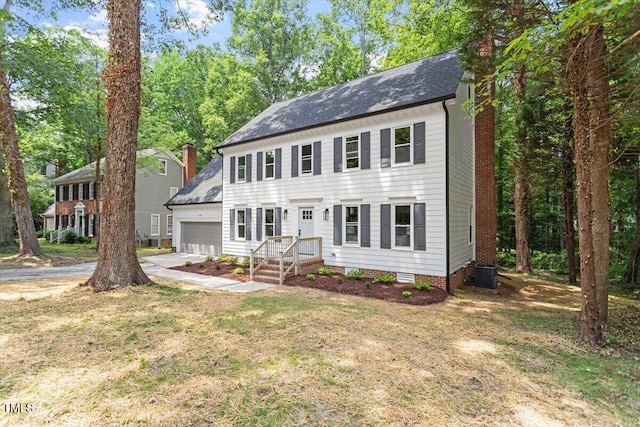 4006 New Yarmouth Way, Apex, NC 27502 - colonial-style house with an attached garage, driveway, a front lawn, and a chimney