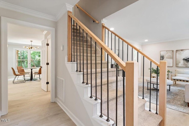 4006 New Yarmouth Way, Apex, NC 27502 - staircase with wood finished floors, a chandelier, crown molding, and recessed lighting