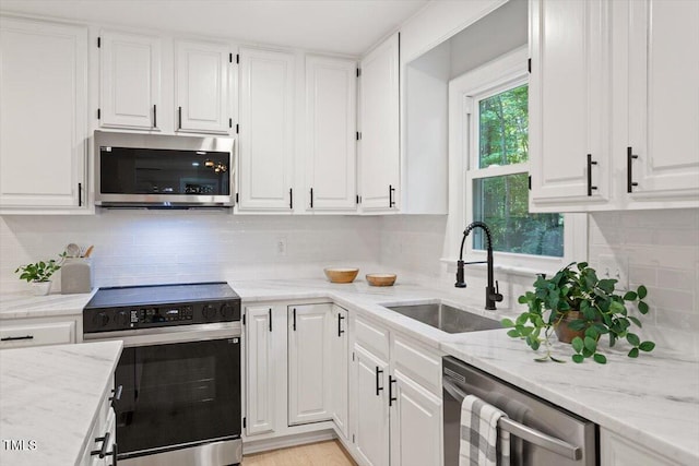 4006 New Yarmouth Way, Apex, NC 27502 - kitchen featuring appliances with stainless steel finishes, white cabinetry, and decorative backsplash