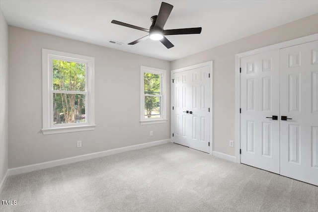 4006 New Yarmouth Way, Apex, NC 27502 - unfurnished bedroom with two closets, carpet, and ceiling fan