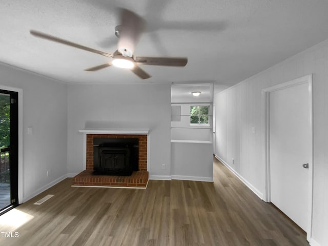 3721 Suffolk St, Durham, NC 27707 - unfurnished living room with wood finished floors, ceiling fan, and a brick fireplace