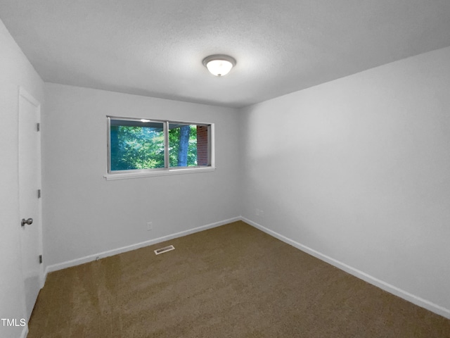 3721 Suffolk St, Durham, NC 27707 - carpeted empty room with baseboards and a textured ceiling