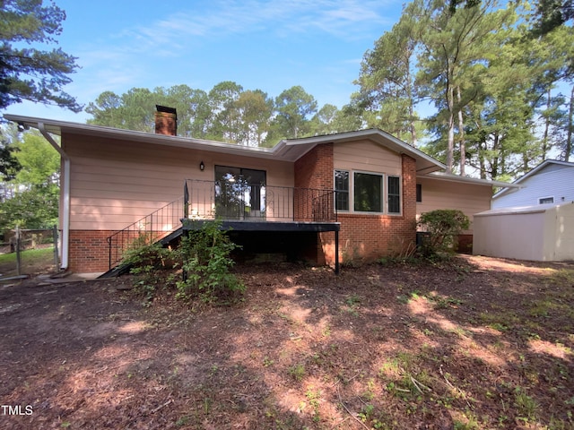 3721 Suffolk St, Durham, NC 27707 - back of property with brick siding, a chimney, stairway, and a deck