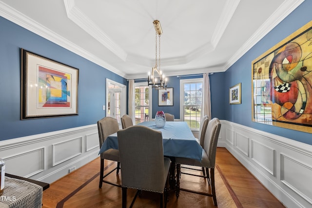 2027 River Grove Ln, Knightdale, NC 27545 - dining room with a raised ceiling, a decorative wall, wood finished floors, ornamental molding, and a chandelier