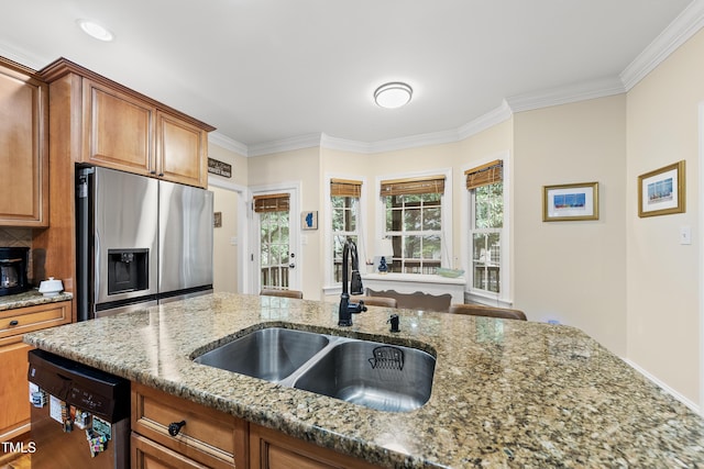 2027 River Grove Ln, Knightdale, NC 27545 - kitchen with stainless steel fridge, dishwasher, crown molding, brown cabinetry, and light stone counters