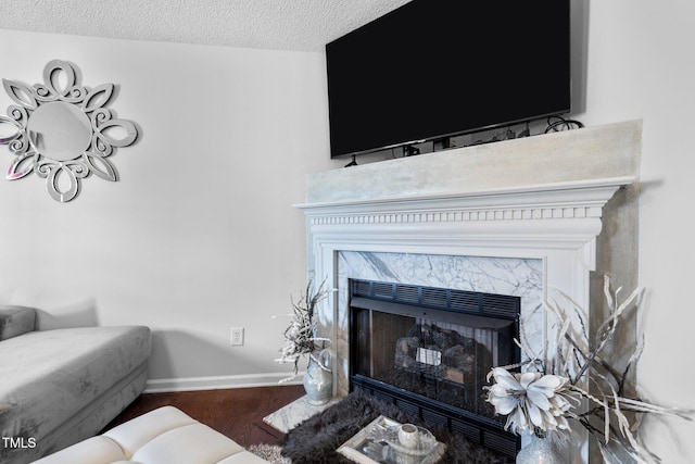 4505 Woodlawn Dr, Raleigh, NC 27616 - detailed view of wood finished floors, a fireplace, and a textured ceiling