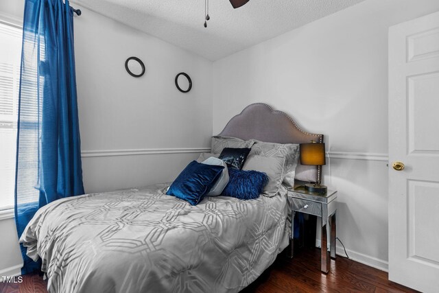 4505 Woodlawn Dr, Raleigh, NC 27616 - bedroom featuring multiple windows, wood finished floors, a textured ceiling, and ceiling fan