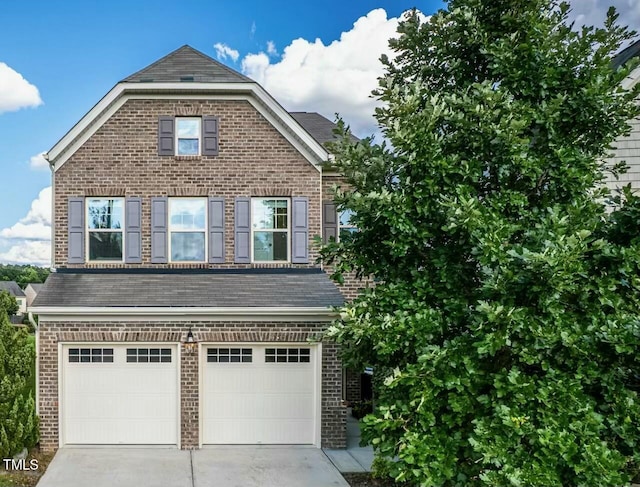 2007 October Dr, Durham, NC 27703 - traditional home featuring brick siding, concrete driveway, and an attached garage