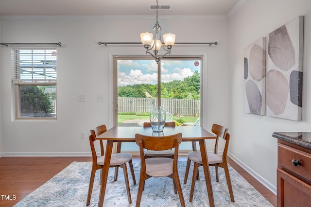 2007 October Dr, Durham, NC 27703 - dining room featuring wood finished floors, crown molding, and a chandelier