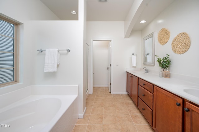 2007 October Dr, Durham, NC 27703 - bathroom with a bath, double vanity, recessed lighting, tile patterned floors, and plenty of natural light
