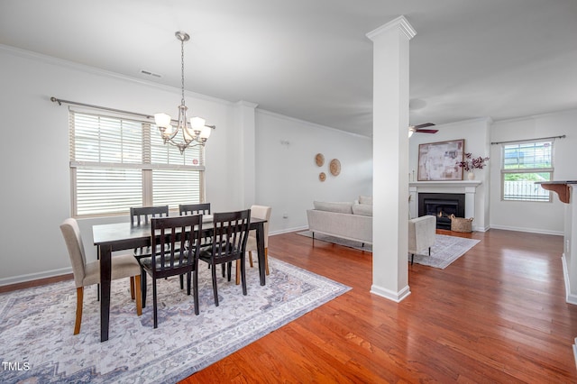 2007 October Dr, Durham, NC 27703 - dining space featuring a ceiling fan, a chandelier, wood finished floors, a glass covered fireplace, and crown molding