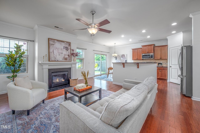 2007 October Dr, Durham, NC 27703 - living area featuring crown molding, recessed lighting, a ceiling fan, dark wood-type flooring, and a fireplace with flush hearth