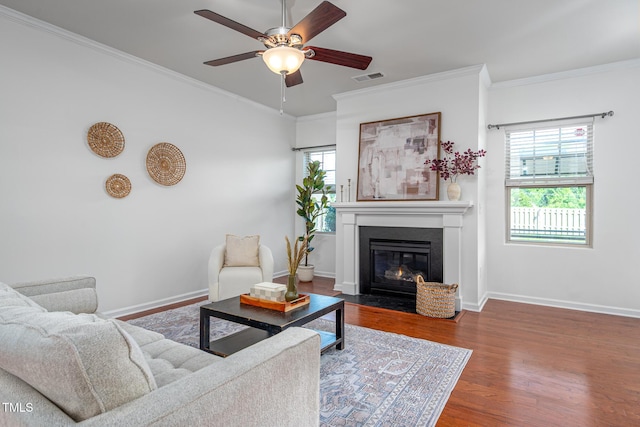 2007 October Dr, Durham, NC 27703 - living area featuring a ceiling fan, wood finished floors, crown molding, and a fireplace with flush hearth
