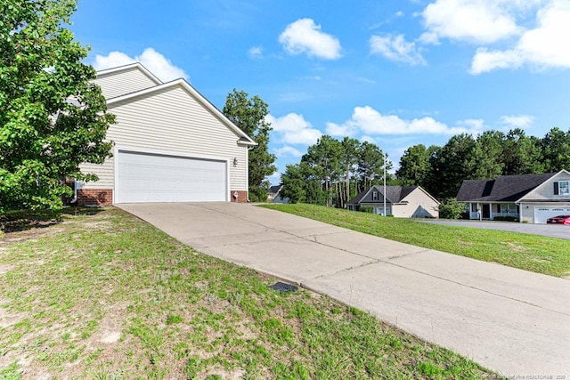 5228 Wallbrook Dr, Fayetteville, NC 28306 - view of side of home featuring driveway, a yard, a garage, and brick siding