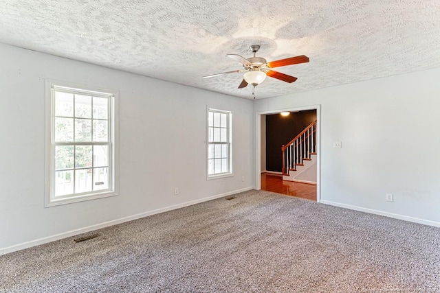 5228 Wallbrook Dr, Fayetteville, NC 28306 - carpeted spare room with stairway, a ceiling fan, and a textured ceiling