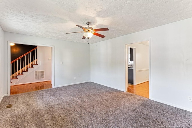 5228 Wallbrook Dr, Fayetteville, NC 28306 - unfurnished room with carpet floors, a ceiling fan, a textured ceiling, and stairway