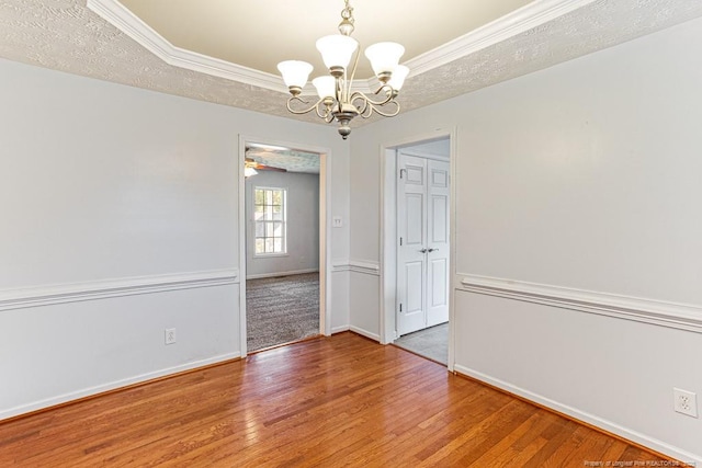 5228 Wallbrook Dr, Fayetteville, NC 28306 - empty room with a chandelier, hardwood / wood-style flooring, crown molding, and a tray ceiling