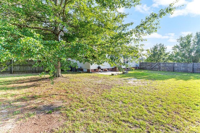 5228 Wallbrook Dr, Fayetteville, NC 28306 - fenced backyard with a patio area