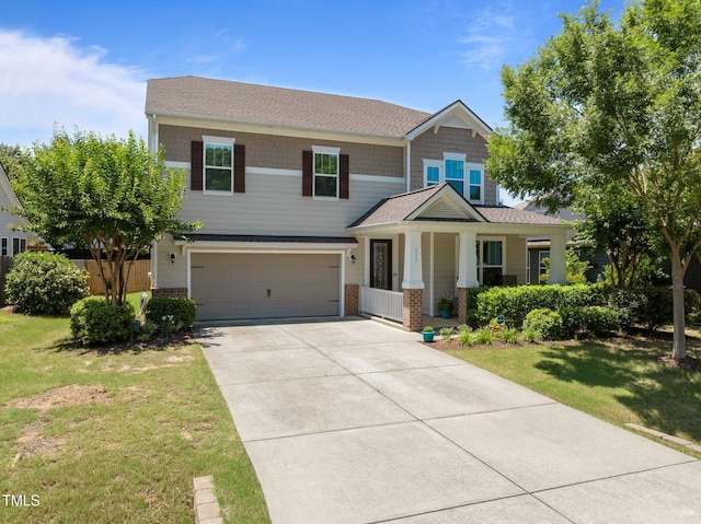 317 Striped Maple Ct, Apex, NC 27539 - craftsman house featuring an attached garage, concrete driveway, a front lawn, a porch, and brick siding