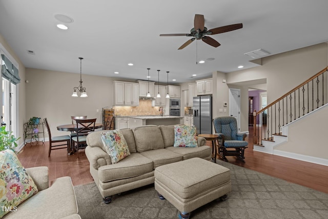 317 Striped Maple Ct, Apex, NC 27539 - living room featuring wood finished floors, a ceiling fan, recessed lighting, and stairway