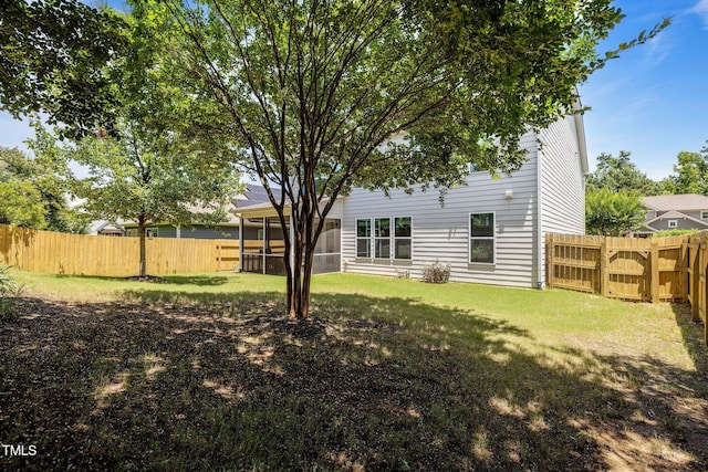 317 Striped Maple Ct, Apex, NC 27539 - rear view of house featuring a fenced backyard and a sunroom