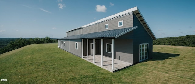 345 Wake County Line Rd, Zebulon, NC 27597 - rear view of house with a patio, a lawn, and a metal roof