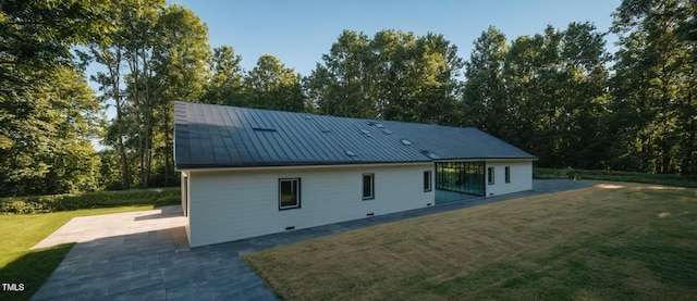 345 Wake County Line Rd, Zebulon, NC 27597 - rear view of house with a patio area, a lawn, and a metal roof