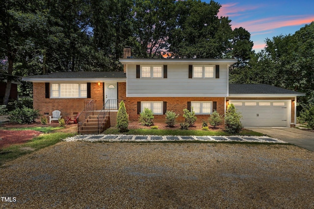 4404 Susan Dr, Raleigh, NC 27603 - split level home featuring concrete driveway, a chimney, brick siding, and a garage
