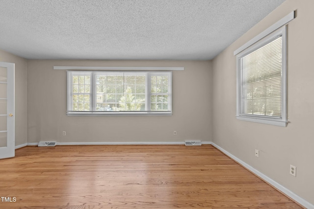 4404 Susan Dr, Raleigh, NC 27603 - empty room with a textured ceiling and light wood finished floors