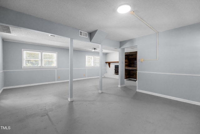 4404 Susan Dr, Raleigh, NC 27603 - below grade area with a fireplace, ceiling fan, and a textured ceiling