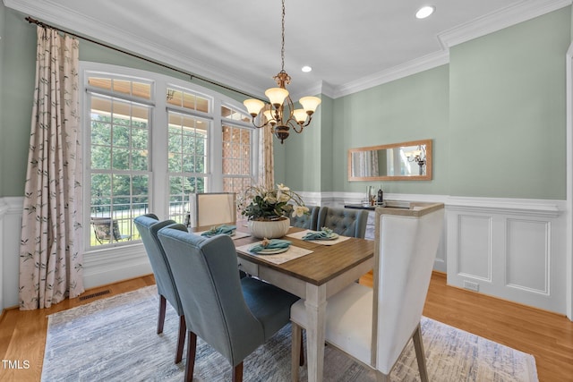 1028 Harpers Ridge Ct, Wake Forest, NC 27587 - dining space featuring a chandelier, crown molding, a wainscoted wall, recessed lighting, and light wood-type flooring