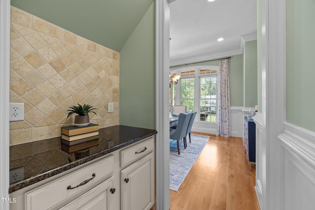 1028 Harpers Ridge Ct, Wake Forest, NC 27587 - kitchen featuring light wood-style floors, decorative backsplash, white cabinets, dark stone counters, and a fireplace