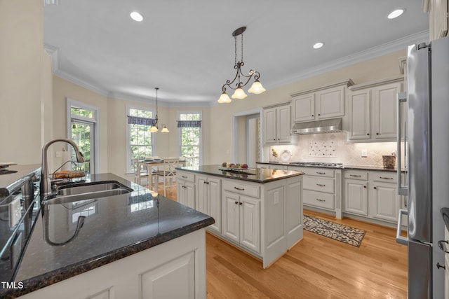 1028 Harpers Ridge Ct, Wake Forest, NC 27587 - kitchen with stainless steel appliances, light wood-style floors, ornamental molding, pendant lighting, and white cabinets
