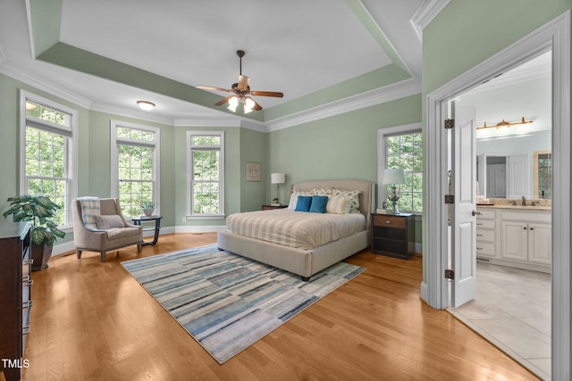 1028 Harpers Ridge Ct, Wake Forest, NC 27587 - bedroom with multiple windows, a raised ceiling, crown molding, and light wood-style flooring