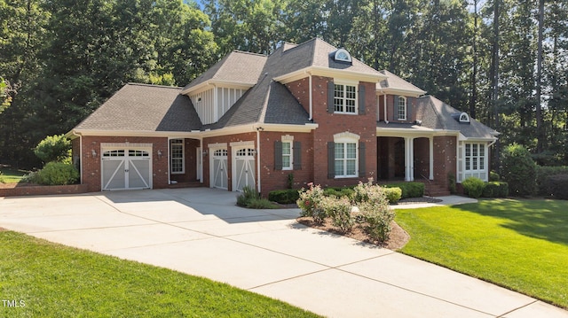 1028 Harpers Ridge Ct, Wake Forest, NC 27587 - view of front of house with an attached garage, brick siding, concrete driveway, a front yard, and a shingled roof