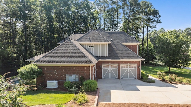 1028 Harpers Ridge Ct, Wake Forest, NC 27587 - view of front facade featuring driveway, brick siding, a front lawn, an attached garage, and a shingled roof