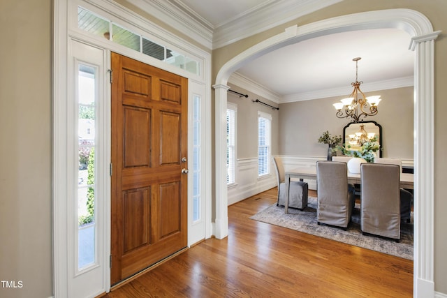 307 Beacon Falls Ct, Cary, NC 27519 - entrance foyer with arched walkways, wood finished floors, ornamental molding, and a chandelier